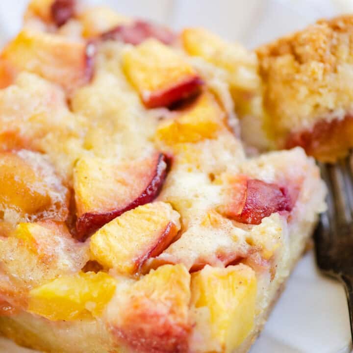 slice of peach custard on plate with bite on fork