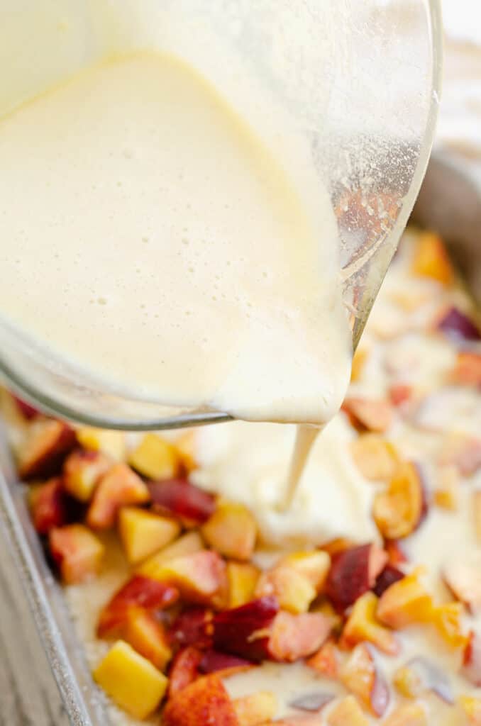 custard poured over fresh peaches