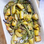 roasted green beans and potatoes in white baking dish