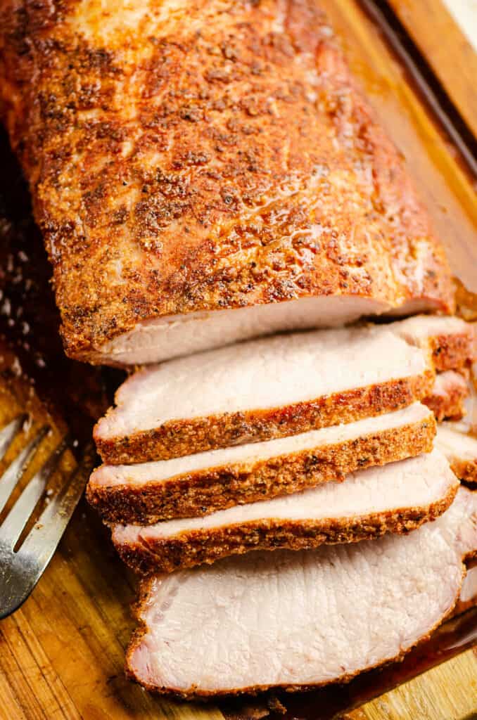 smoked pork loin sliced on cutting board