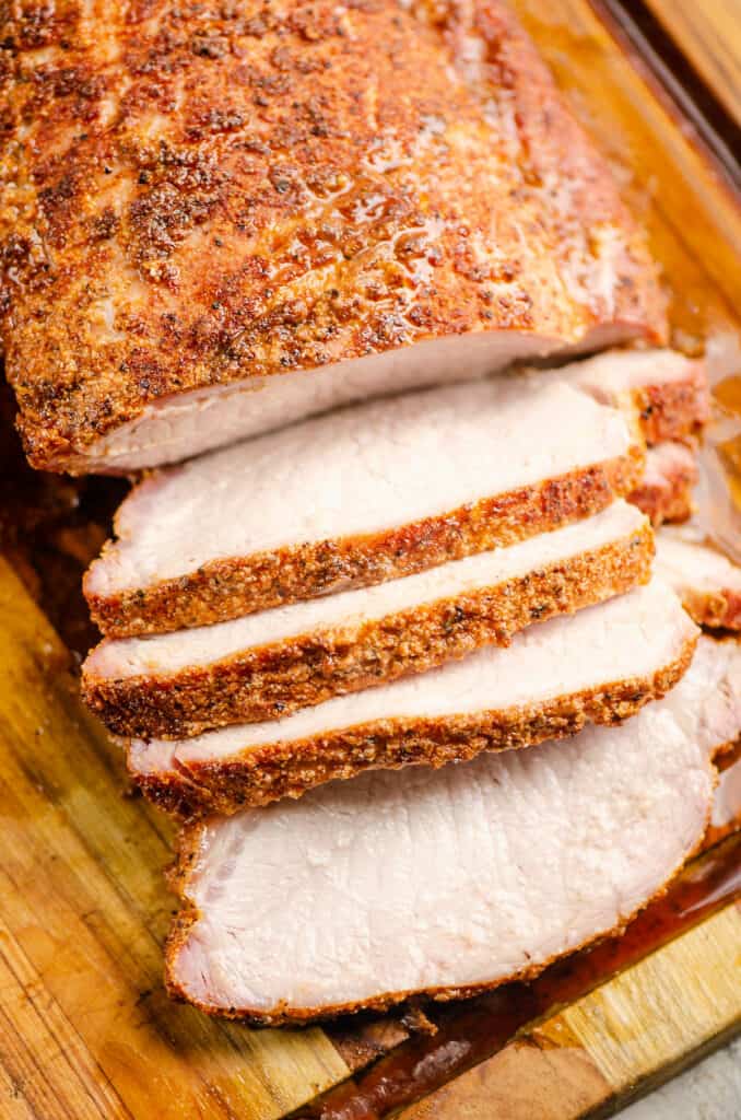seasoned pork loin sliced thinly on cutting board