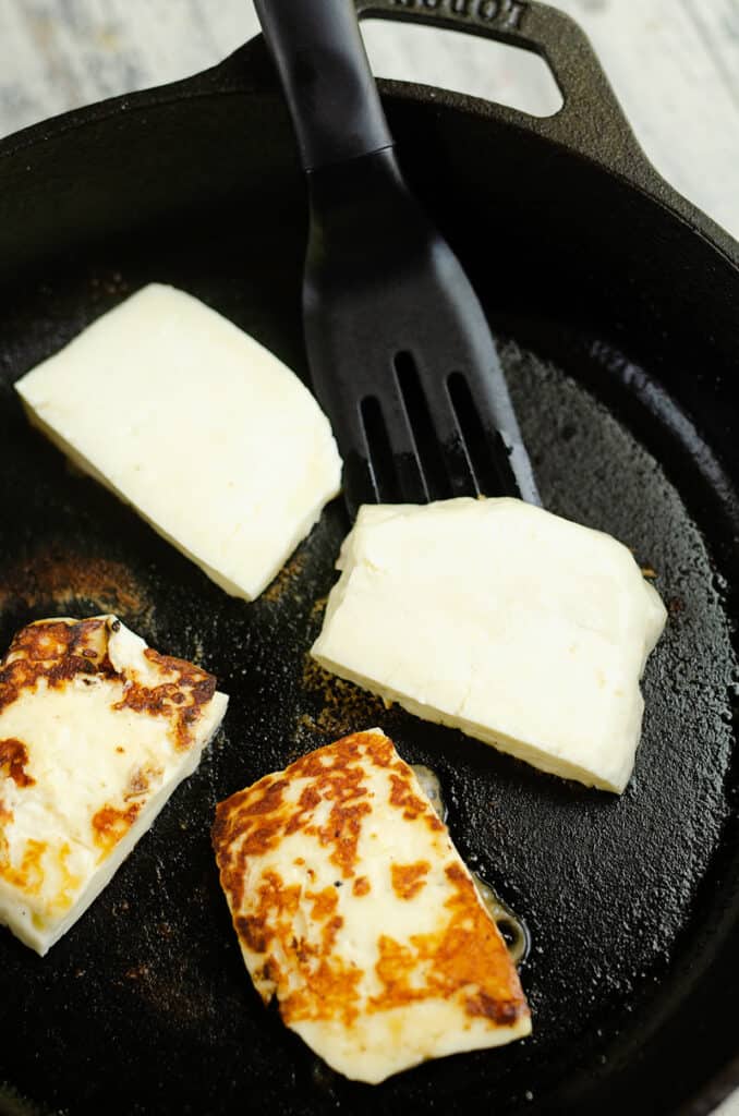 grilled halloumi cheese in cast iron pan