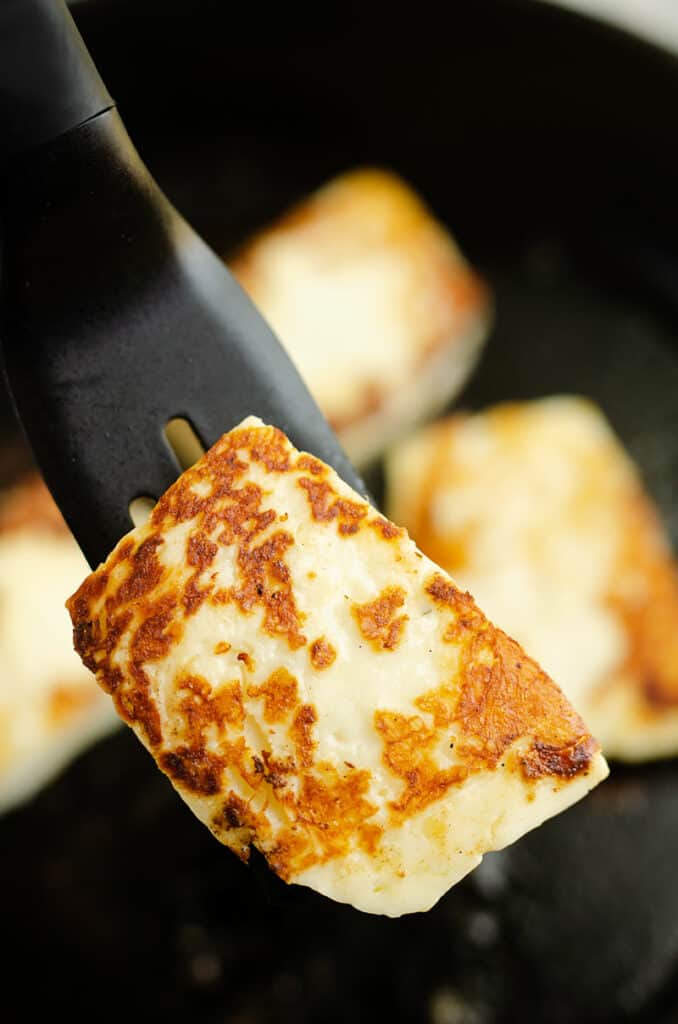 grilled halloumi cheese on spatula