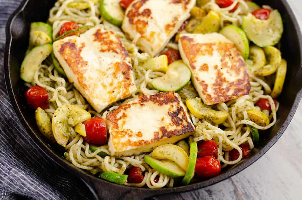 grilled halloumi cheese and vegetable pasta in pan