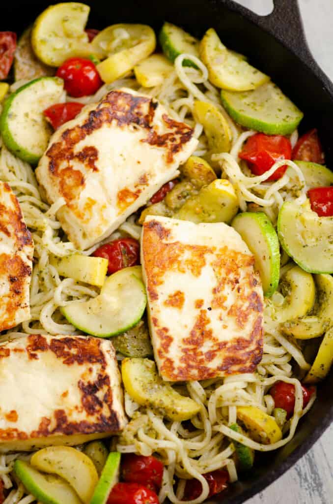 grilled halloumi cheese and pesto pasta in pan