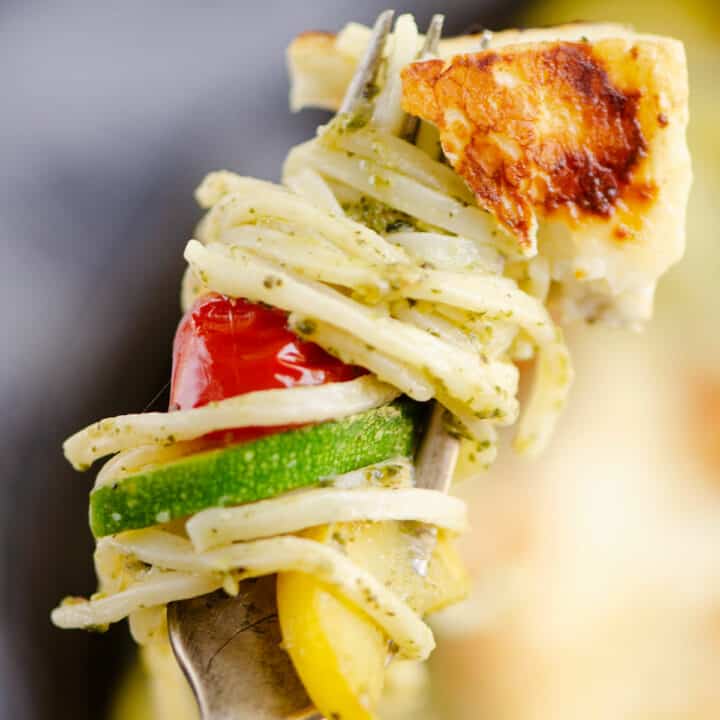 grilled halloumi cheese and vegetable pasta on fork
