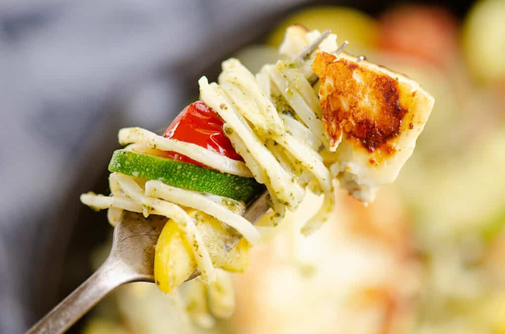 grilled halloumi cheese and vegetable pasta wrapped around fork