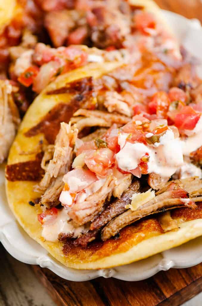 crispy cheese pork carnitas on flour tortillas with pico