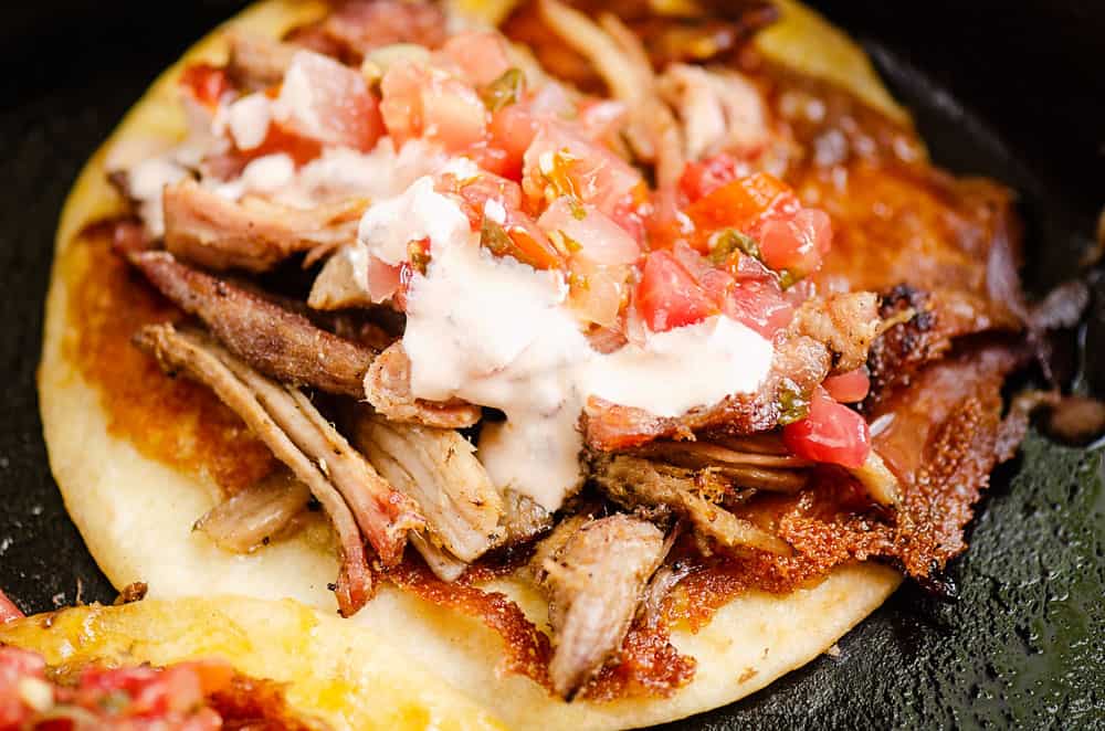 crispy cheese pork carnita taco cooked in cast iron skillet