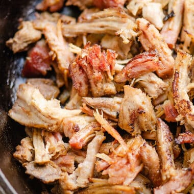 smoked pork carnitas sautéed in cast iron pan