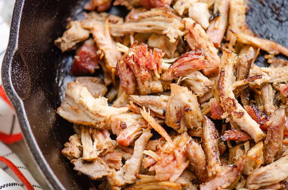 smoked pork carnitas sautéed in cast iron pan