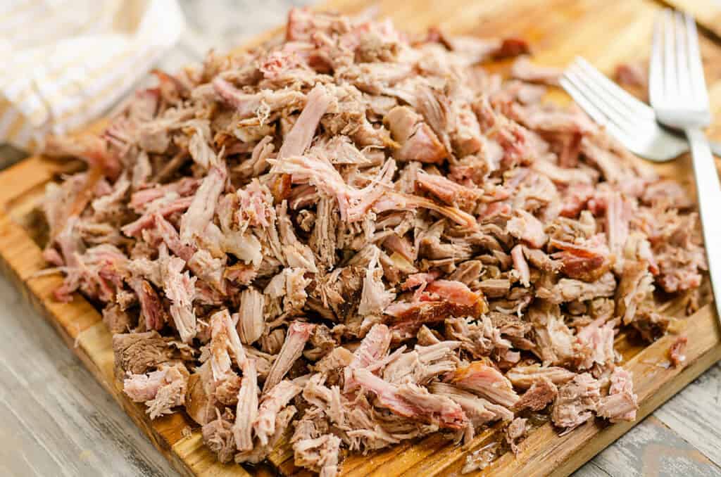 pork carnitas shredded on cutting board with forks