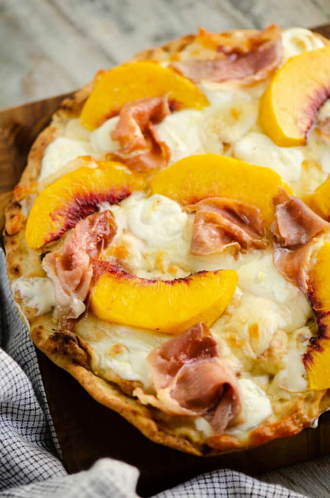 Peach and prosciutto Naan Pizza on cutting board