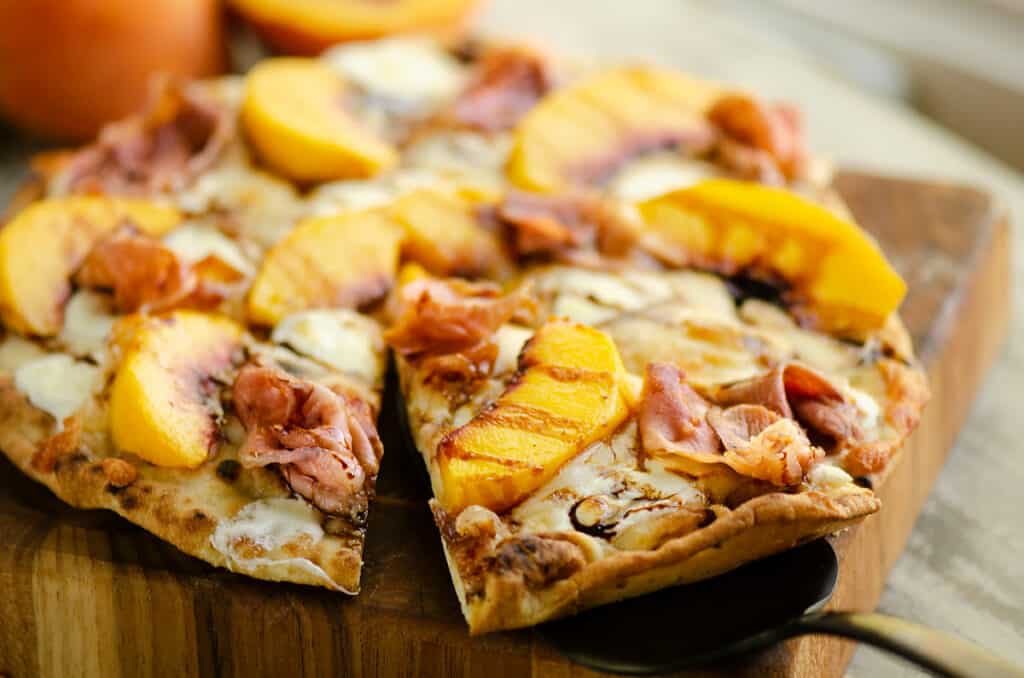 slice of peach pizza on server