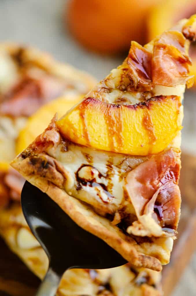 slice of Air Fryer peach pizza topped with balsamic glaze