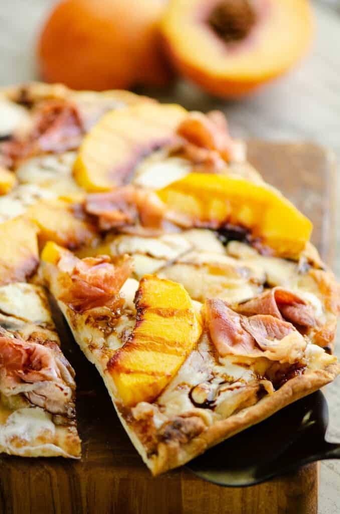 slice of peach pizza removed from pizza