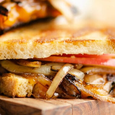 Grilled cheese with apples and balsamic onions on cutting board