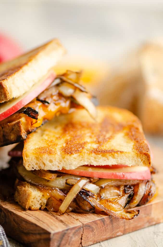 Grilled sourdough sandwich with cheddar, apples and onions