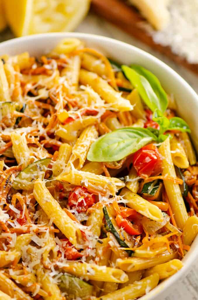 Pasta Primavera in white bowl with fresh basil