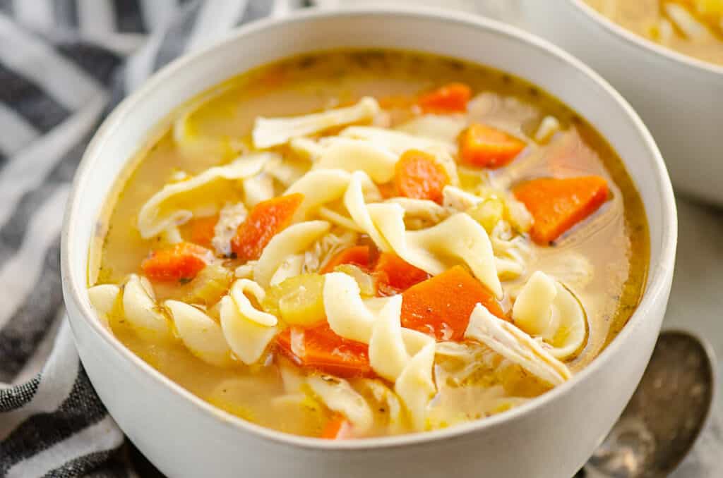 bowl of Greek chicken noodle soup in bowl with spoon