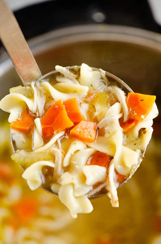 ladle of bowl of Greek chicken noodle soup