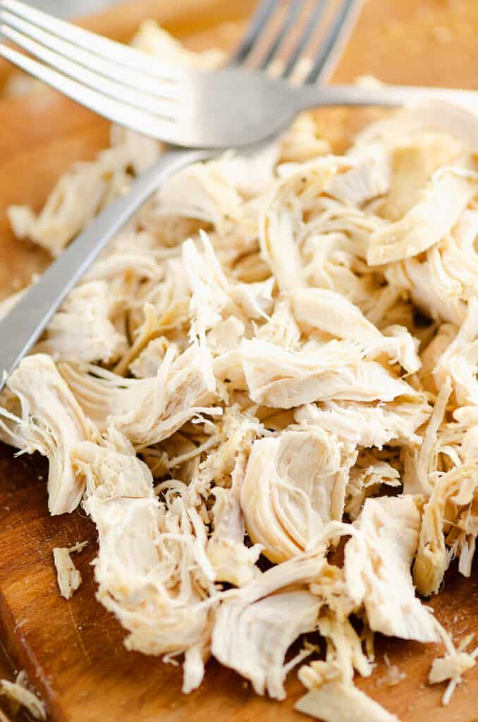 shredded chicken on cutting board