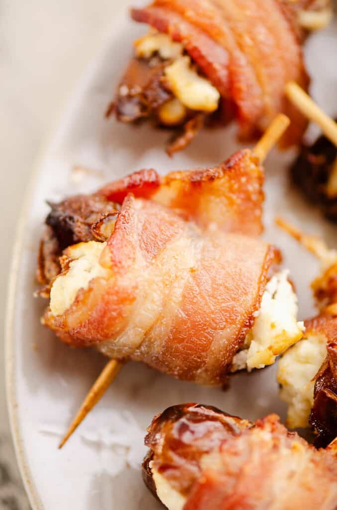 bacon wrapped date with toothpick on plate