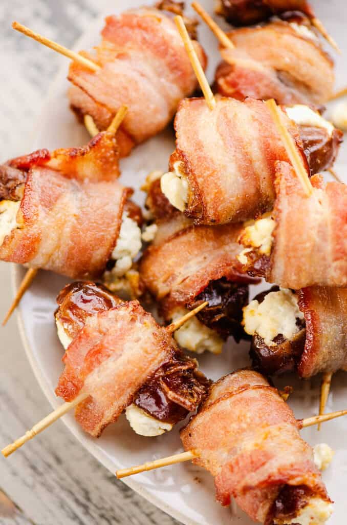 white platter with bacon wrapped goat cheese dates