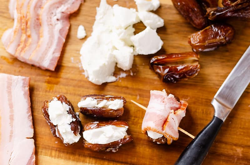 bacon, goat cheese and dates wrapped on cutting board
