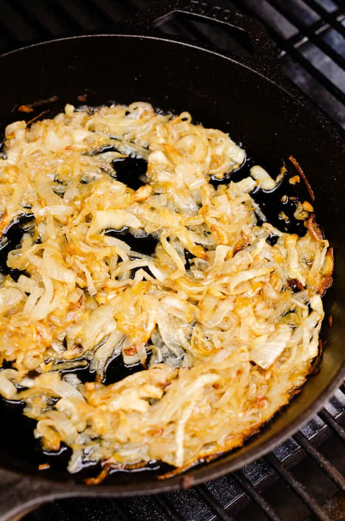 smoked caramelized onions in cast iron skillet on pellet grill