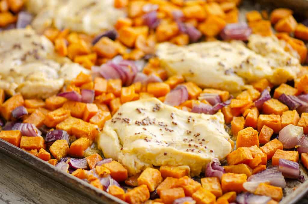 honey mustard chicken breast and sweet potatoes on sheet pan
