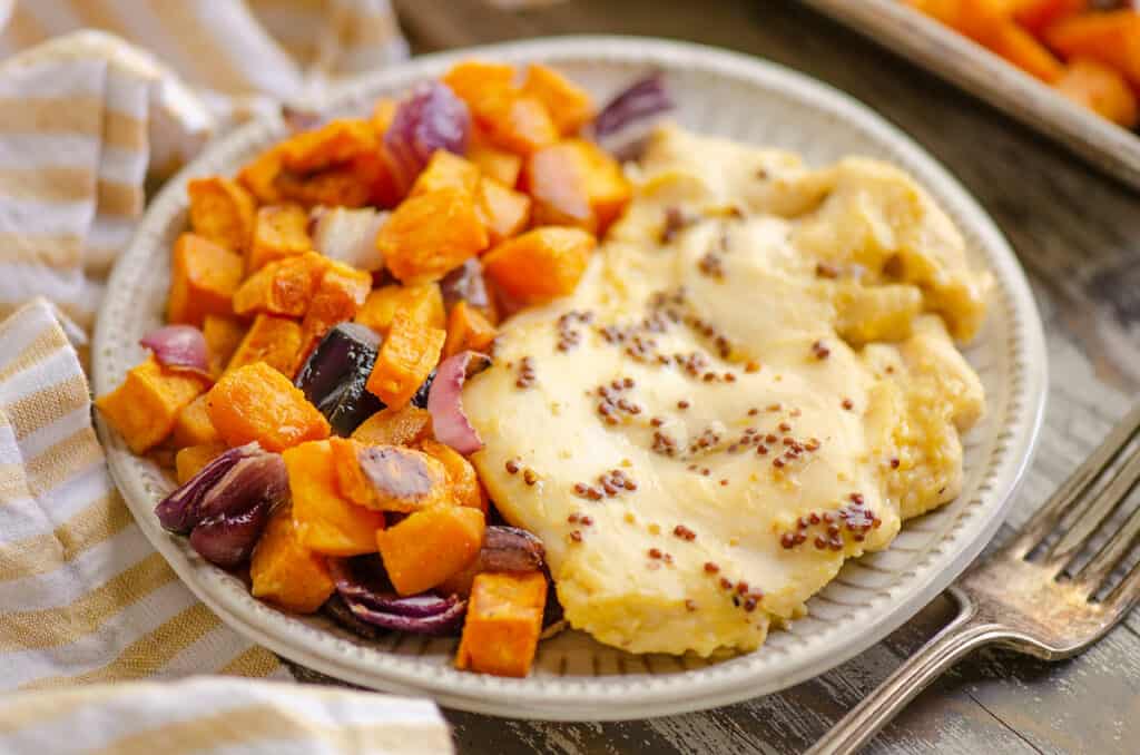 honey mustard chicken breast and roasted sweet potatoes on plate