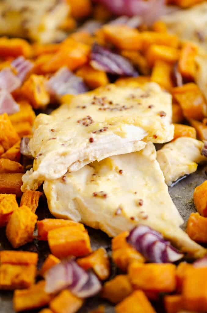 tender honey mustard chicken breast and sweet potatoes on sheet pan