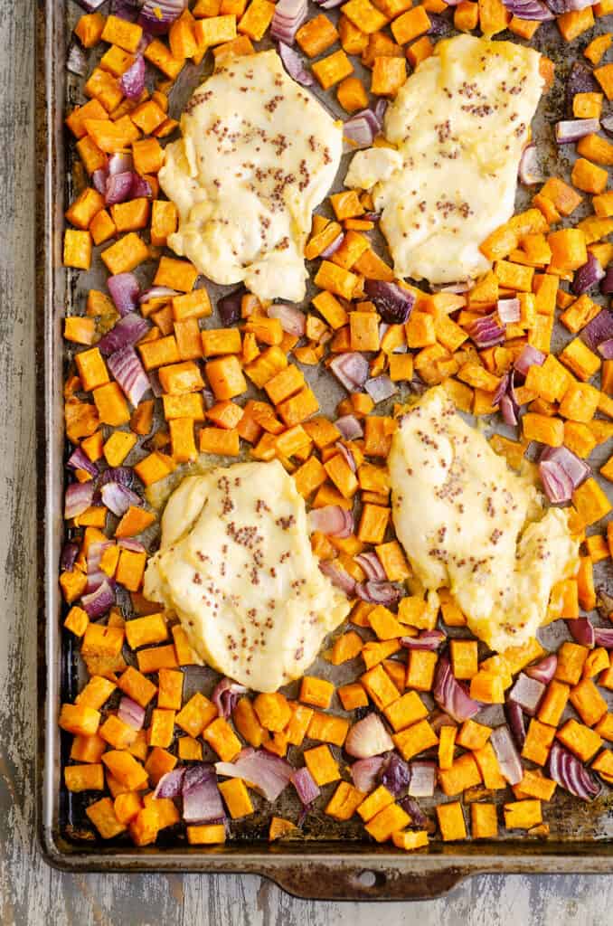 honey mustard chicken breast and sweet potatoes with onions on sheet pan