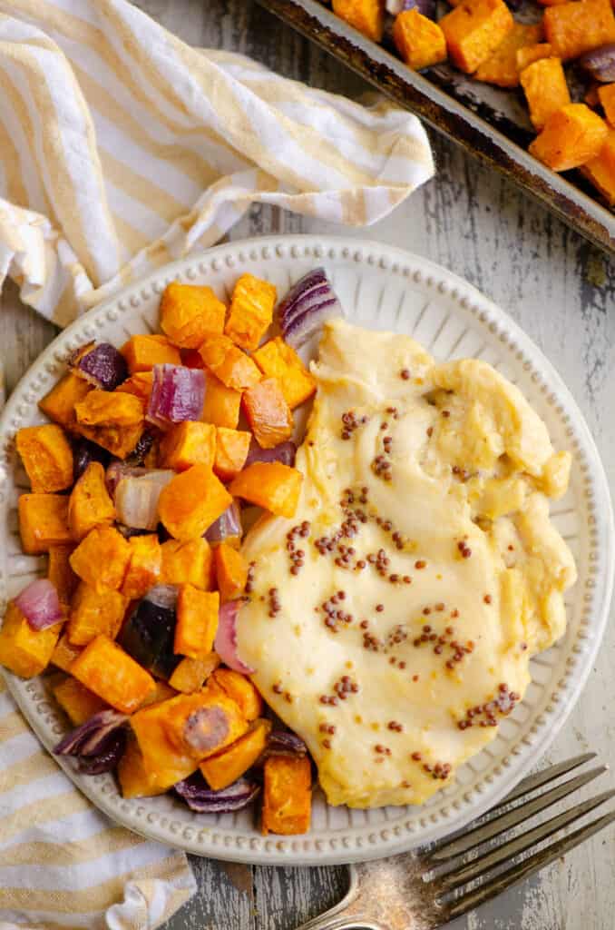 honey mustard chicken breast and roasted sweet potatoes on white plate