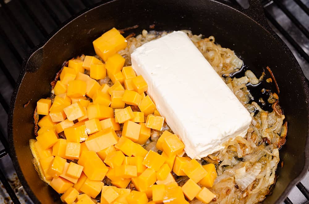 cheddar, caramelized onions and cream cheese in skillet on pellet smoker