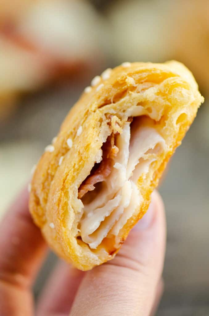 inside of turkey bacon swiss crescent roll in hand