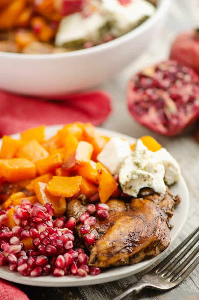 balsamic chicken & butternut squash dinner with with pomegranates and goat cheese on plate