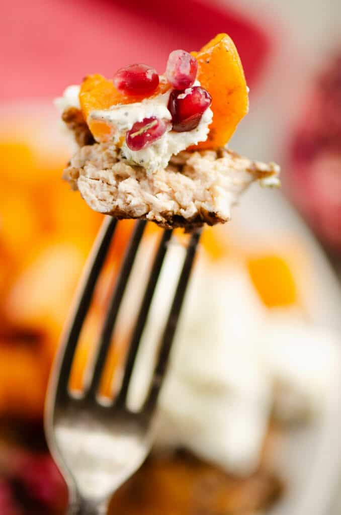 balsamic chicken & butternut squash with goat cheese and pomegranates on fork