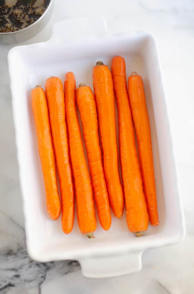 peeled carrots in roasting pan