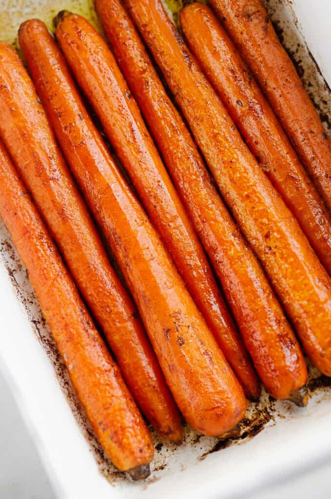 brown butter roasted carrots in white baking pan