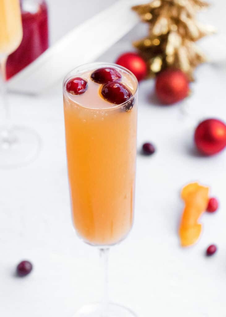 mimosa glass topped with cranberries