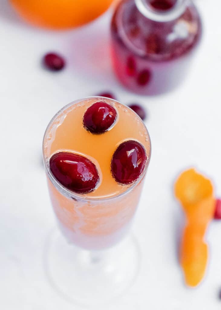 mimosa glass topped with cranberries