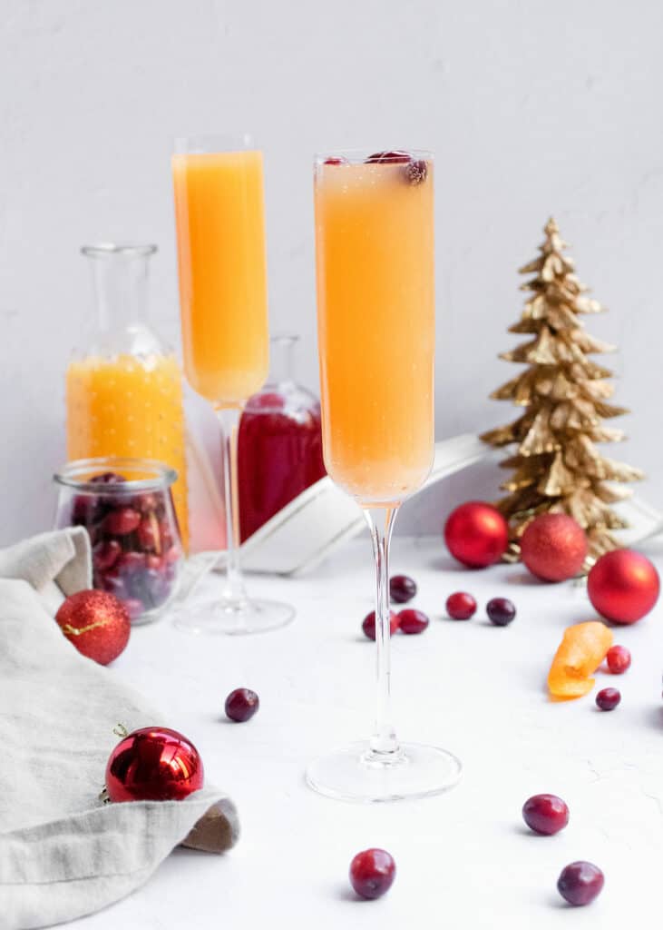 cranberry orange mimosa on table with holiday decor