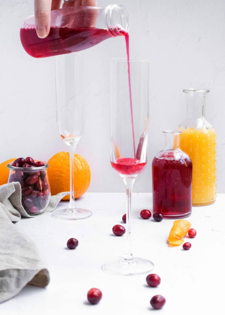 cranberry juice poured into mimosa glass