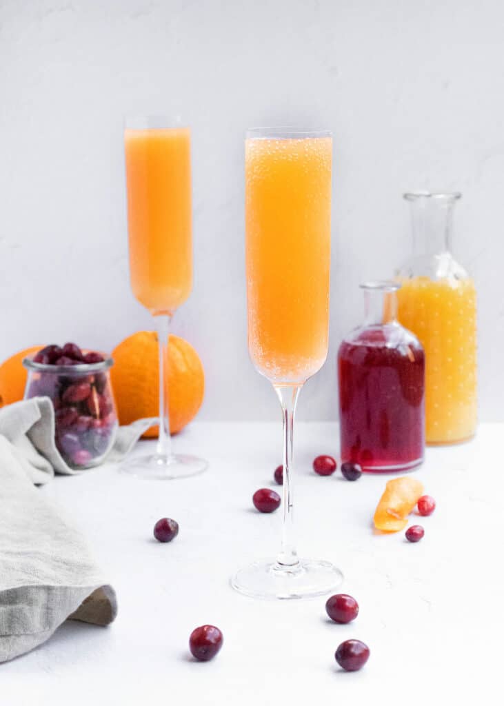 cranberry orange mimosa on white table