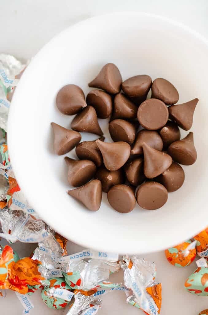 Hershey kisses unwrapped in white bowl