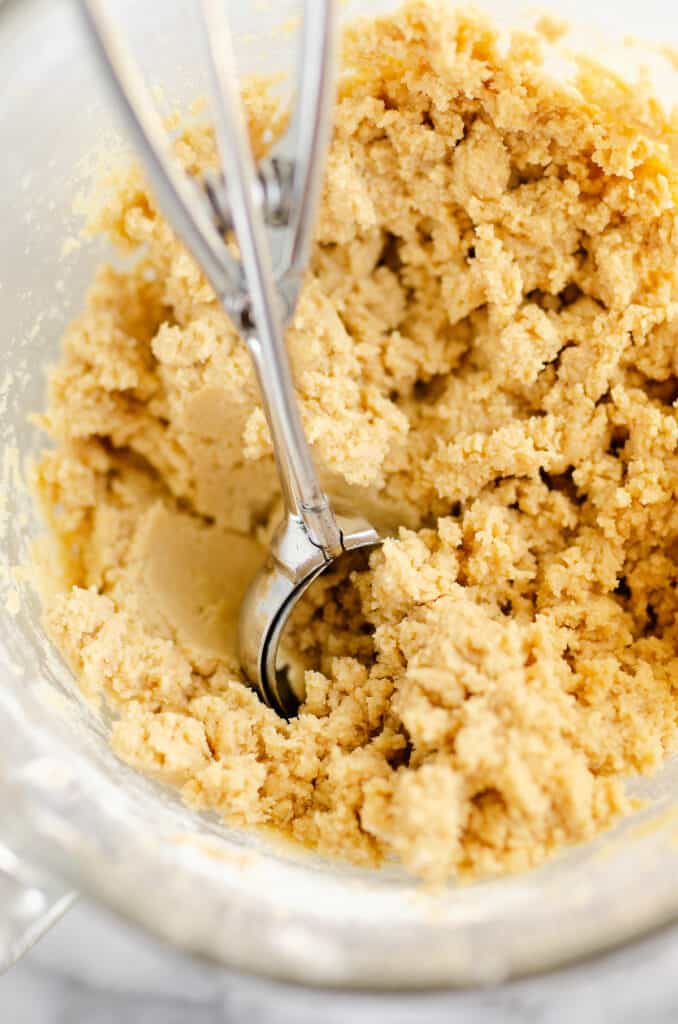 peanut butter cookie dough with scoop in bowl