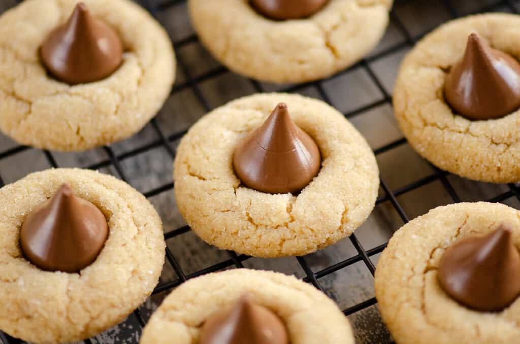 peanut butter blossom cookies on black cooling rack