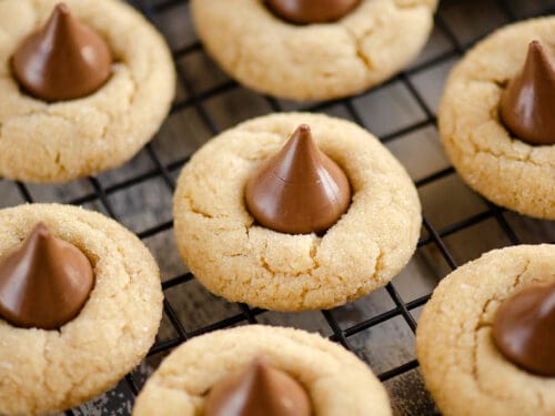 peanut butter blossom cookies on black cooling rack